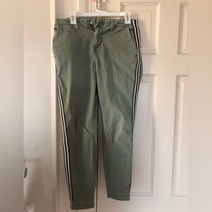 Army green L’Agence skinny pants with sparkly stripe down leg